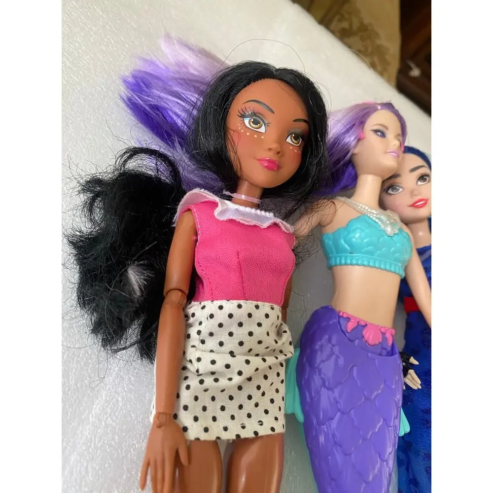 three dolls Barbie Dreamtopia Mermaid Doll with purple hair and purple-and blue